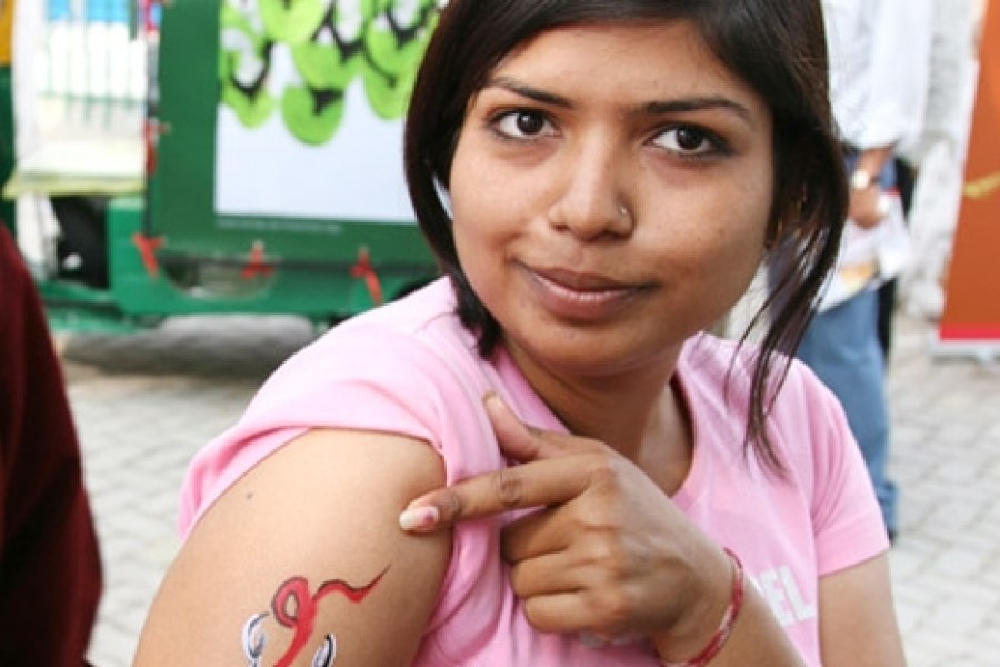 Participant with an AIDS awareness ribbon painted on their arm at the ArtMoves debut