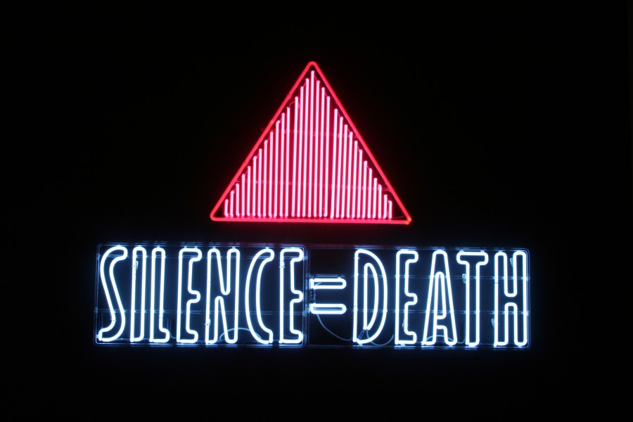 Gran Fury and ACT UP’s neon *SILENCE=DEATH* sign displayed in the exhibition