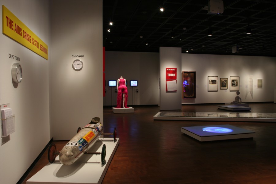 Wide gallery view of multiple works in the “Who Lives, Who Dies?” and “Are You Afraid to Touch?” sections