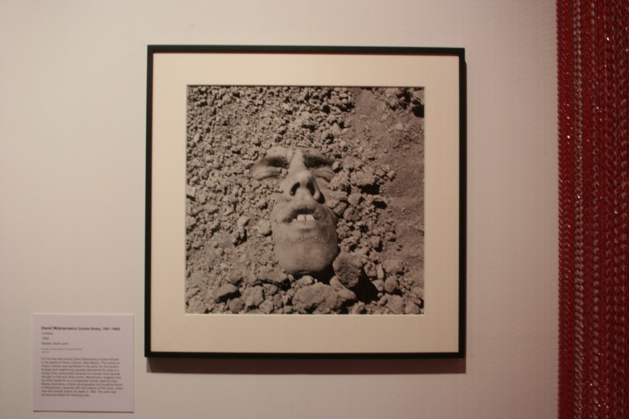 David Wojnarowicz partially buried in the earth in *Untitled (Face in Dirt)*