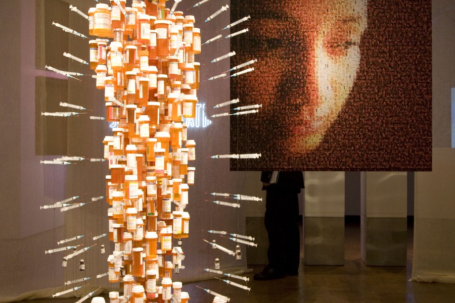Daniel Goldstein and John Kapellas’s *Medicine Man* at center left and Lewis Evans’s *UNAIDS cover image for Global Report, 2004* at center right