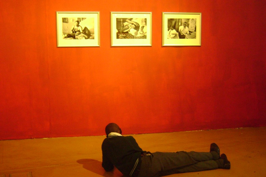 Visitor in front of Dayanita Singh’s three portraits of HIV caregivers in India