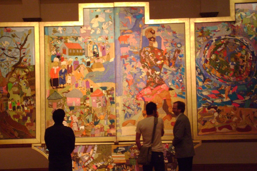 Co-curator David Gere and visitors standing before the Resurrection layer of the *Keiskamma Altarpiece*
