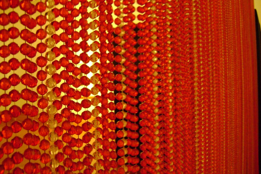 Red beaded curtain-like element in the gallery