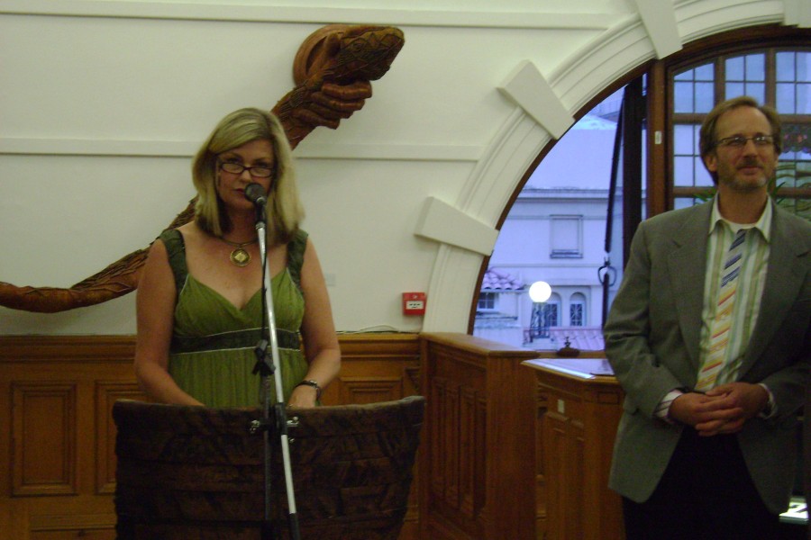 Speaker addressing attendees alongside David Gere