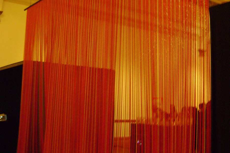 Red beaded curtain-like element in the gallery
