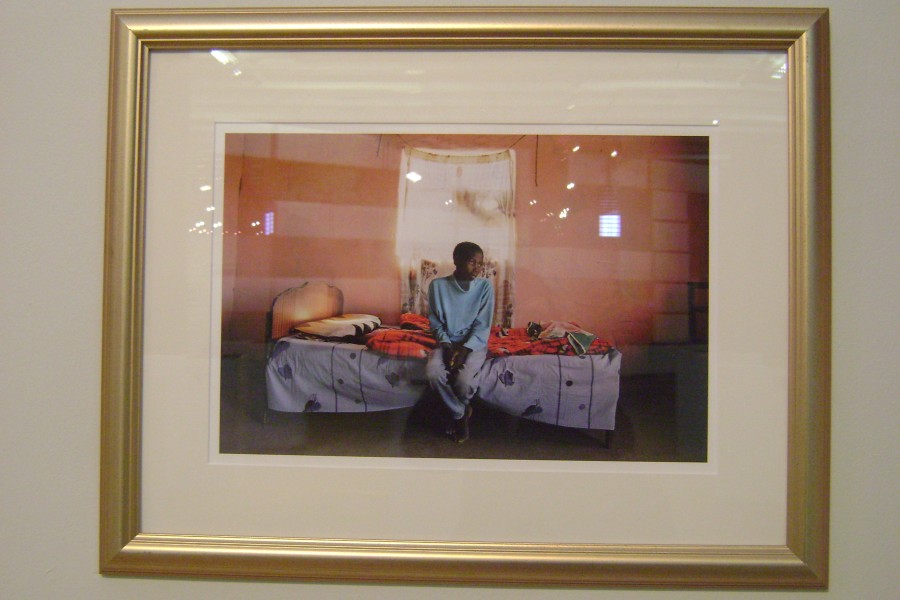 Gideon Mendel’s photograph of Nomfumaneko Yako seated on her bed before beginning antiretroviral treatment