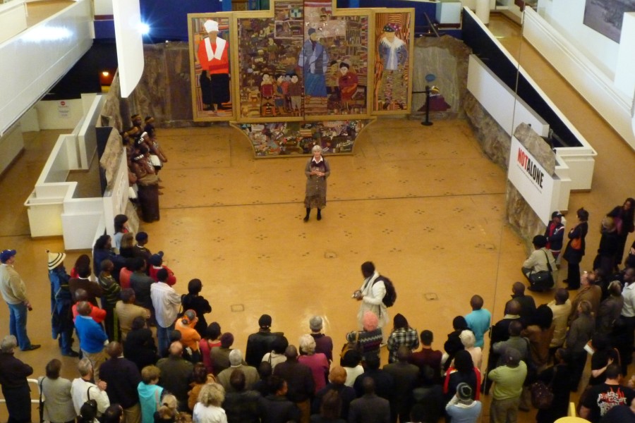 Visitors listening to a speaker near the *Keiskamma Altarpiece*