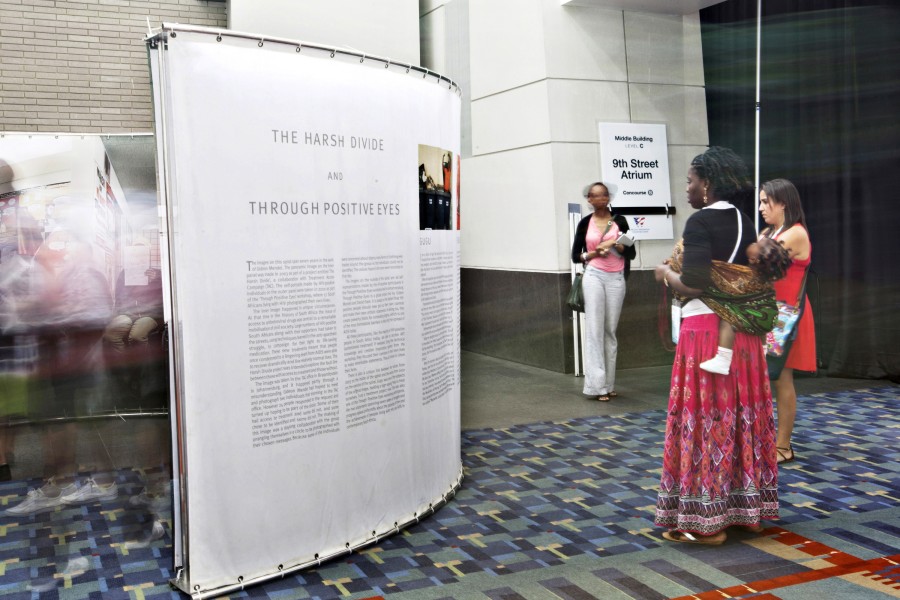 Gideon Mendel’s *The Harsh Divide and Through Positive Eyes* spiral installation