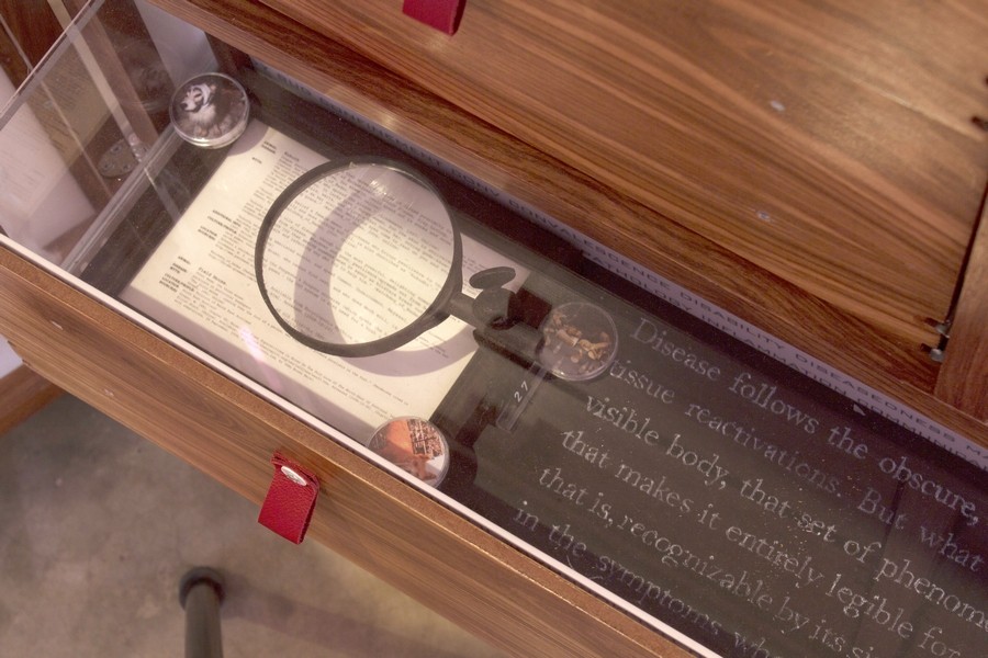 Magnifying glass and text in a drawer by Fritha Langerman