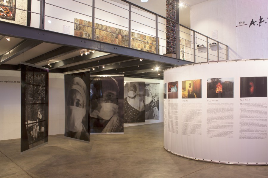 Wide view of Gideon Mendel’s spiral installation beside The Harsh Divide