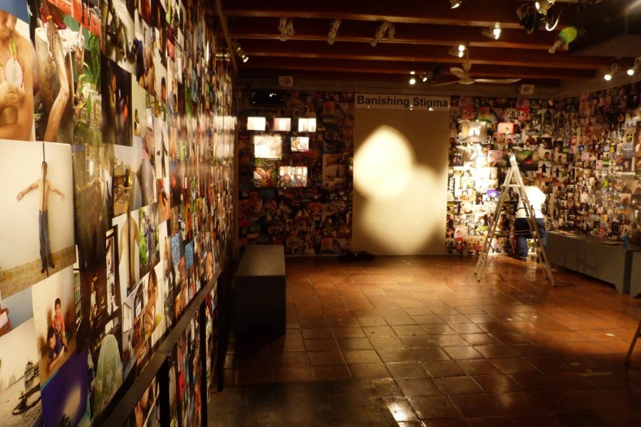 Gallery walls covered with wallpaper composed of photographs by Through Positive Eyes artivists