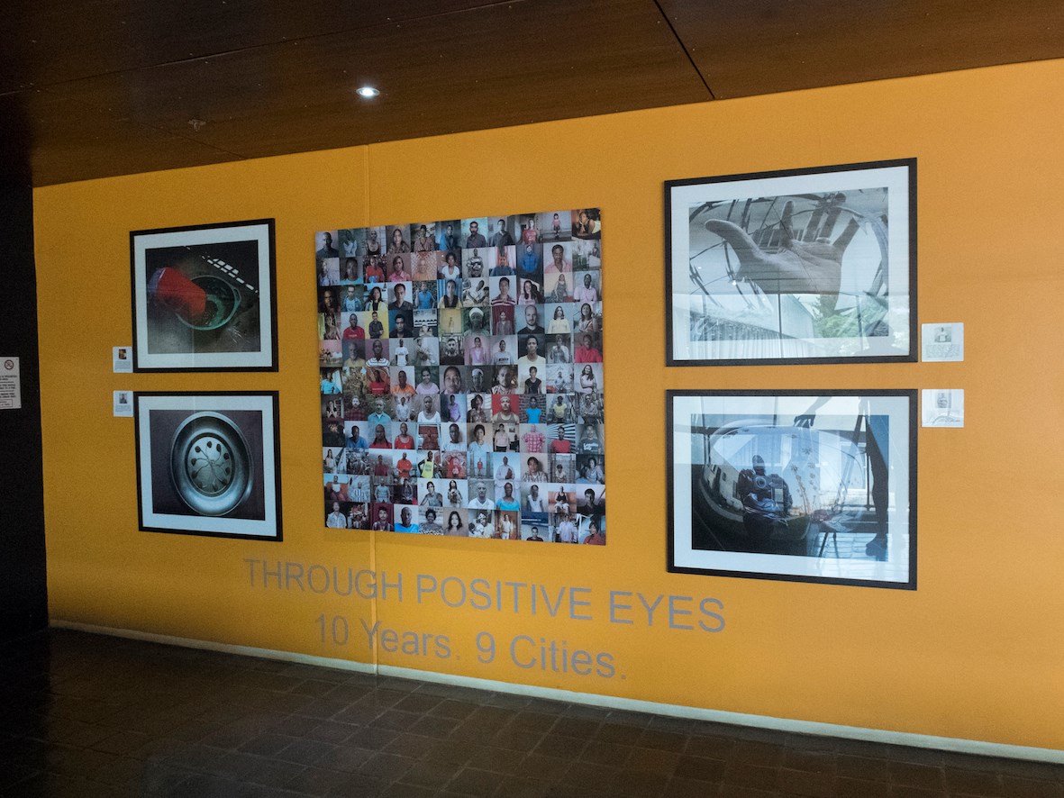 Gideon Mendel’s composite portraits flanked by four framed photographs above the exhibition title