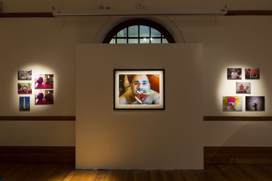 Framed photograph by London artivist Isaac centered among other gallery works