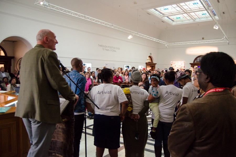 Visitors and artivists gathering at the exhibition opening