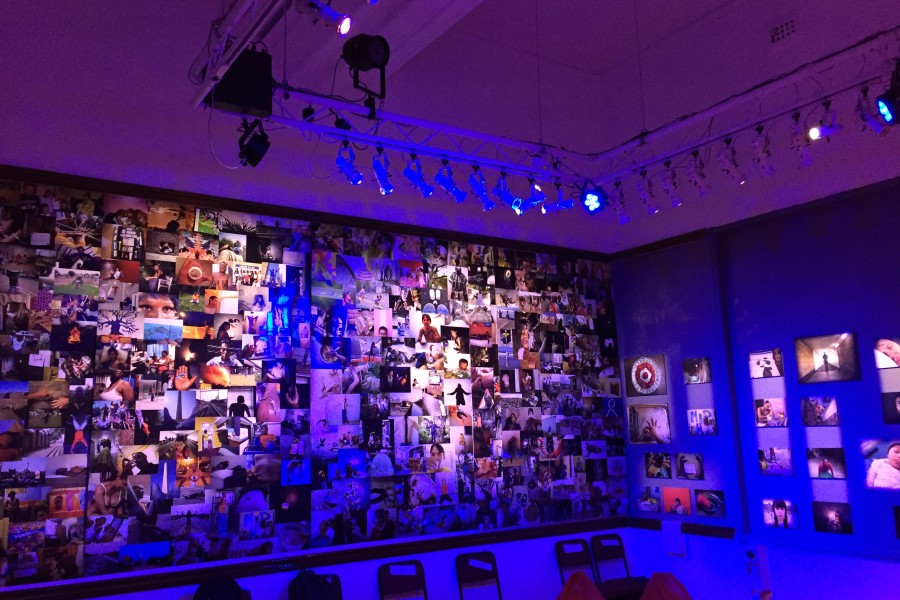 Banishing Stigma Room with photographic wallpaper on one wall and prints displayed on another