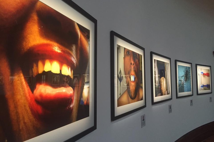 Individually illuminated framed photographs in the dimly lit *My Photo. My Story.* section