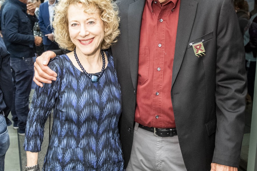 Marla Berns posing with a visitor at the exhibition opening