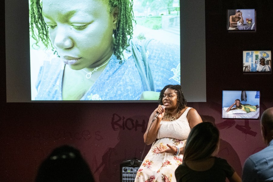 Lynnea storytelling with her photograph displayed behind her