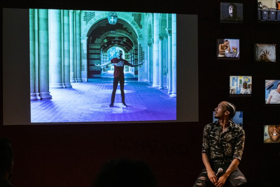 Thomas storytelling with his photograph projected on the screen behind him