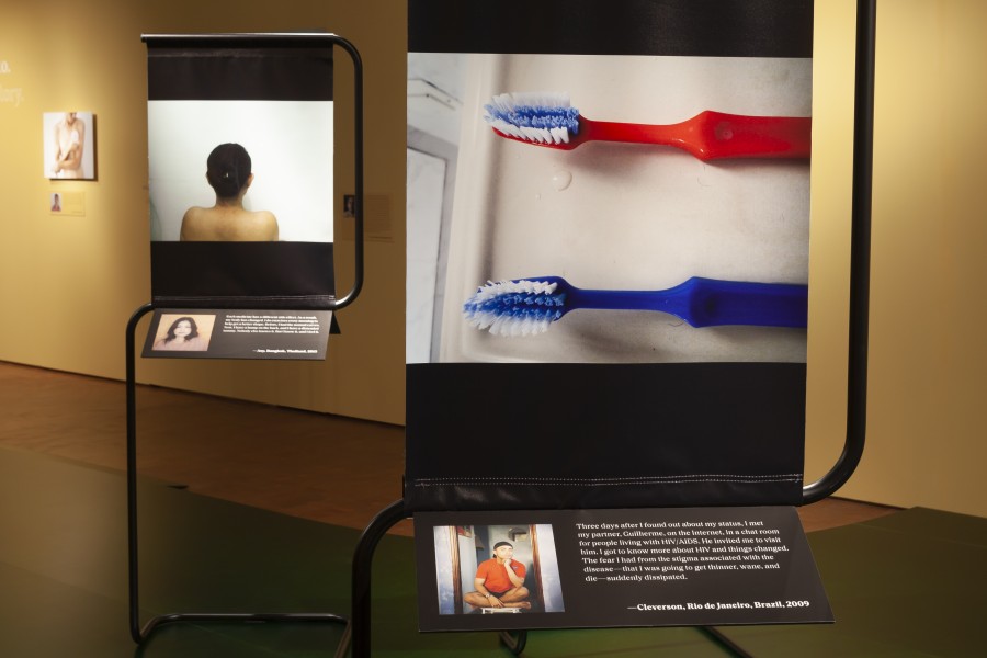 Photographs and stories by Through Positive Eyes artivists displayed with portraits by Gideon Mendel