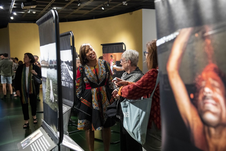 Visitors viewing photographs and stories by Through Positive Eyes artivists