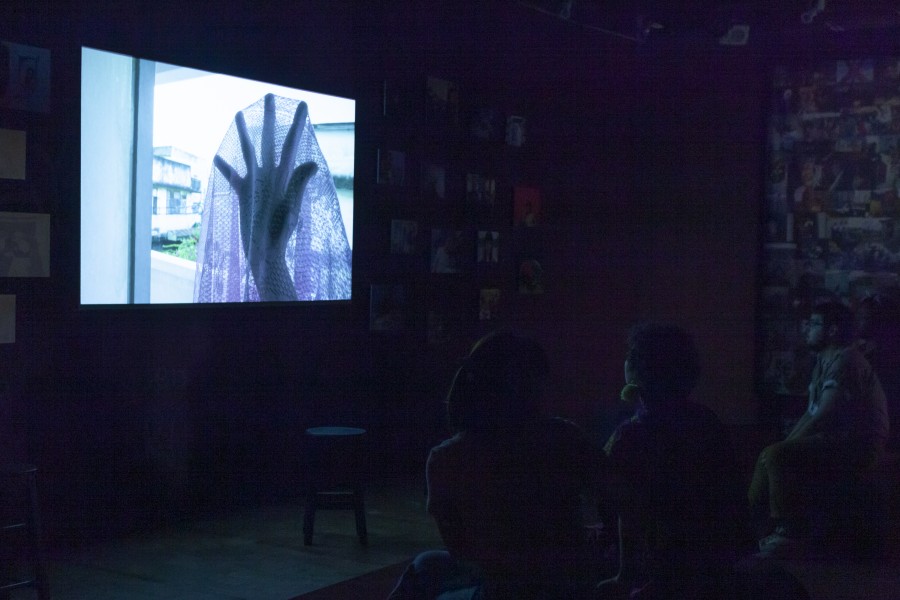 Banishing Stigma Room seating facing a projected photograph by a Through Positive Eyes artivist