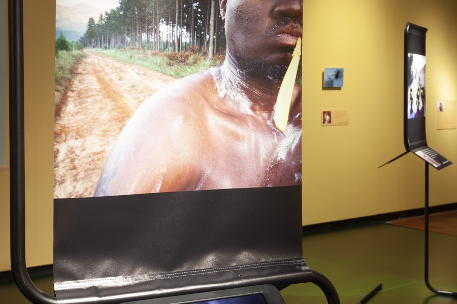 Photograph by Kau displayed above an iPad playing a video about him