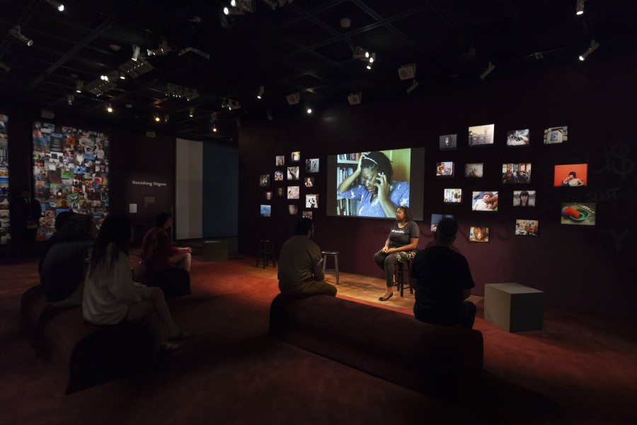 Audience listening as Lynnea shares her photo-story in the Banishing Stigma Room