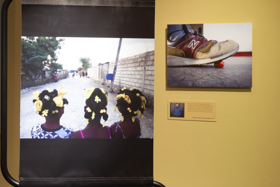 Displays for Wideline of Port-au-Prince at left and Gordon of London at right, with their photographs, stories, and portraits by Gideon Mendel