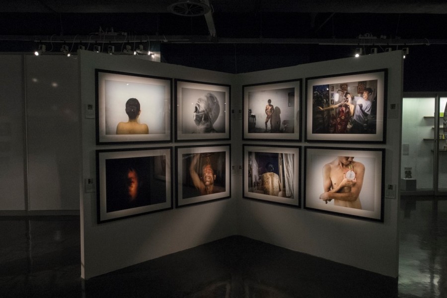 Gallery view with individually illuminated photographs by Through Positive Eyes artivists
