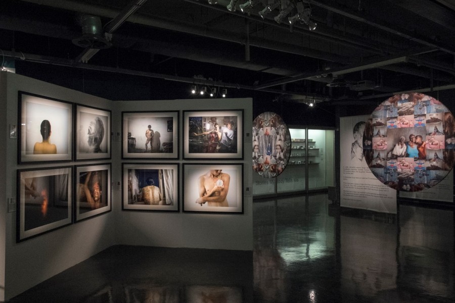 Gallery view with framed photographs and a photographic mandala to the right